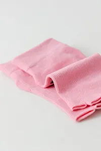 Detailed close-up shot of pink split-toe yoga socks showing soft knit texture and neat fold.