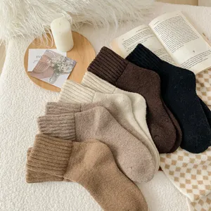 Primer plano detallado de calcetines de lana de invierno gruesos en colores sólidos con textura suave.