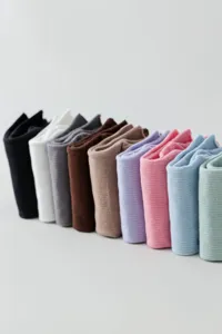 Detailed close-up of colorful knitted socks neatly folded and arranged in a diagonal row.