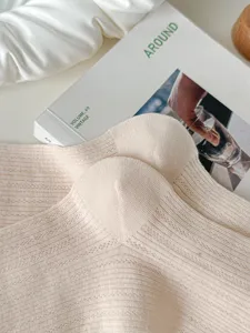 Close-up detail shot of light beige women mesh breathable mid-calf slouch socks texture.