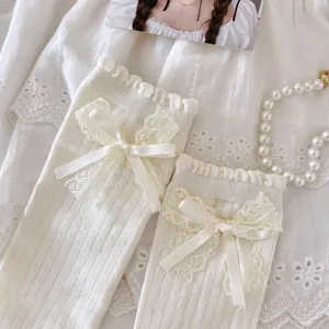 Sweet Japanese style white knit mid-calf socks with delicate lace bow decorations for women.
