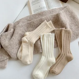 Close-up of soft ribbed knit winter wool socks in neutral tones, cozy texture detail.