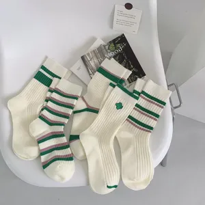 Chic green striped women mid-tube socks with clover embroidery, Japanese college style.
