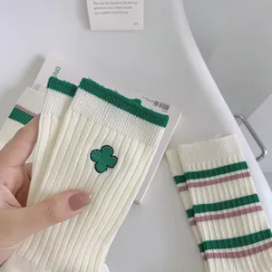 Green clover embroidered socks detail view, cozy cotton striped mid tube socks for women.