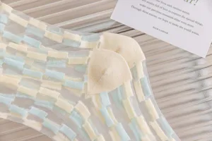 Sheer mesh socks for women featuring a chic check pattern in pastel yellow and blue tones.