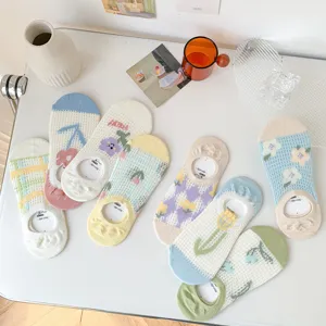 Detail view of cute Japanese style cotton mesh low cut boat socks with floral patterns.