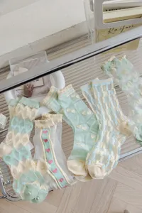 Detailed view of sheer summer women socks with cute heart and plaid patterns for daily wear.