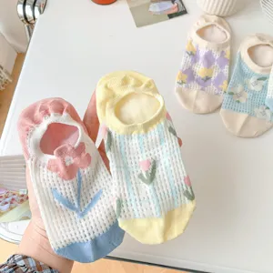 Close-up detail of cute floral mesh boat socks, breathable cotton and comfortable invisible design.