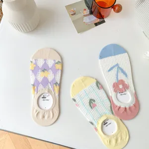 Close up view of breathable mesh low cut socks with cute floral patterns and anti slip grips.