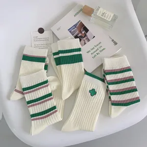 Green striped mid-tube women socks with cute clover embroidery, stylish Japanese college style.