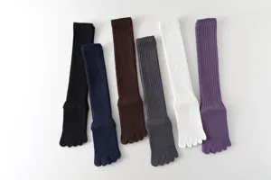 Detailed view of five toe yoga pilates socks in various colors with ribbed long design.