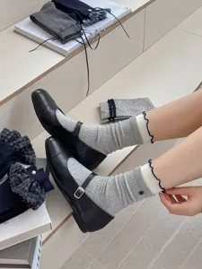 Grey ribbed mid-calf socks with delicate frilly lace and button detail for daily wear.