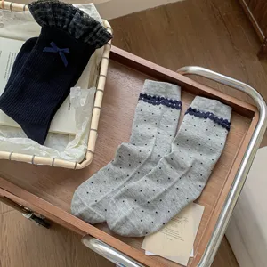 Cute Japanese style women mid tube socks with plaid ruffles and bows, breathable cotton.