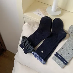 Cute blue-grey mid-calf socks with plaid ruffle cuffs and delicate pearl button details.