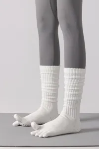 White five-toe yoga socks detail, long grip pilates socks with non-slip dots for women.