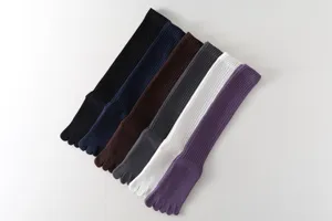 Detailed view of long five-toe yoga socks for women, ribbed knit athletic sports wear.