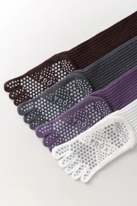 Detailed view of five-toe yoga socks with anti-slip dots, long tube pilates design.
