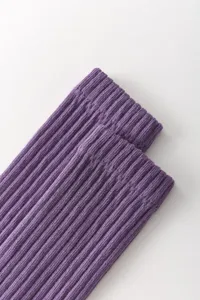 Purple ribbed knit detail shot of yoga calf socks, showing fine texture and elastic fabric.