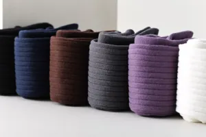 Close-up detail of rolled ribbed compression calf socks in multiple solid colors for daily wear.