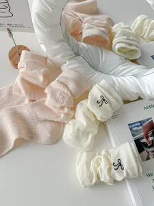 Close-up detail of women's sweet bow embroidered mesh crew socks, breathable spring style.