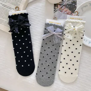 Sweet polka dot mid-calf socks for women, featuring cute lace ruffles and bow accents, JK style.