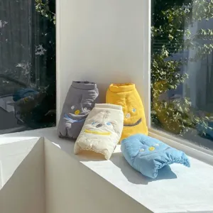 Pet winter warm cotton coat detail view, thick cozy apparel with cute smiley face for small dogs.