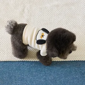 Detailed close-up view of cute thick fleece pet dog clothes with 3D ears and cartoon graphic.