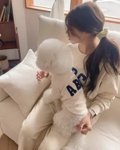 Cozy lifestyle detail of pet matching sweatshirt featuring embroidered letters for small dogs.