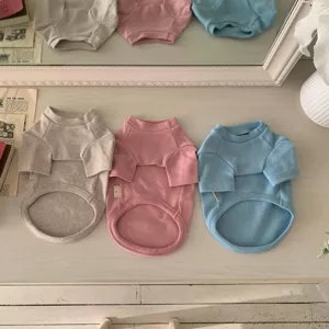 Detailansicht von weichen Haustier-Fleecepullovern in Grau, Rosa und Blau für Hunde und Katzen.