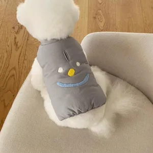 Cute grey dog winter vest with adorable embroidered smiley face, warm pet coat detail shot.