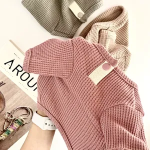 Detailed view of soft waffle knit pet shirt texture, comfortable fabric for small dogs and cats.