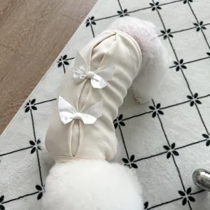 Cozy cream pet sweatshirt detail featuring elegant white satin bows for small dogs in winter.
