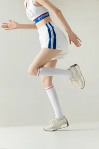White over-the-knee sports long socks for women, stylish activewear knee-high socks.