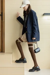 Japanese college style brown knee-high socks with double stripes and cute embroidery details.