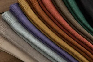 Close-up detail view of soft winter warm terry knit solid color socks stacked neatly.