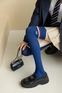 JK style blue over-the-knee long socks for women with contrast stripes and cute embroidery crest.