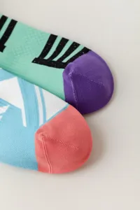 Close-up detail of stylish knit high socks featuring contrast colors and geometric patterns.