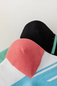 Close-up detail of women's sports knit socks, showing soft texture, pink heel and striped design.