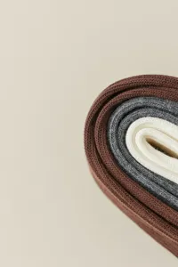 Close up detail view of soft knit socks texture, cozy casual autumn style, neutral tone.