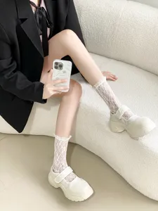Detail shot of women's ultra-thin sweet lace ruffle mid-tube socks, spring summer Lolita style.
