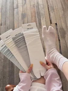 Detail shot of breathable split-toe socks in various colors, comfortable cotton slouch socks.