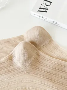 Close-up detail of thin transparent summer women socks showcasing delicate knit hollow-out patterns.