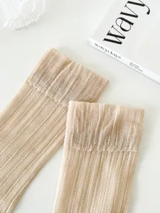 Sheer thin summer ice socks close-up, beige ribbed elastic slouch stockings texture detail