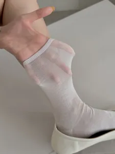 Detail shot showing the lightweight sheer texture and breathable stretch of this solid white socks.