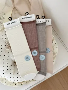 Detailed view of summer thin mulberry silk mid-tube solid color socks with hanging tags.
