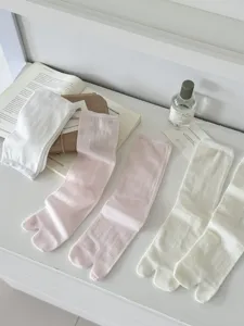 Detailed view of women's split-toe socks, comfortable cotton material in solid colors.