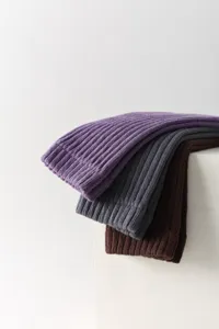 Detailed view of ribbed knit compression sports tube socks in purple, grey and brown colors.