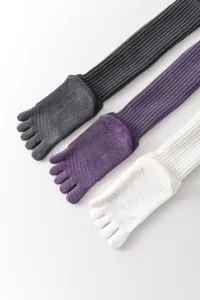 Detailed view of women's five-toe yoga socks, long anti-slip pilates split-toe socks.