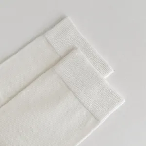 Detail shot of white silk tabi socks, showing fine knit texture, lightweight summer socks.