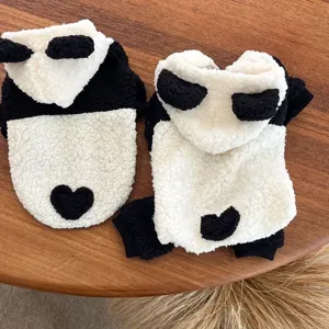 Detailed view of the cute panda plush dog costume, showing fluffy texture and heart detail.